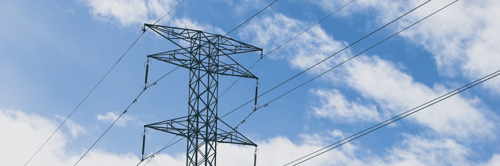 Electric Towers With Blue Cloudy Sky Background