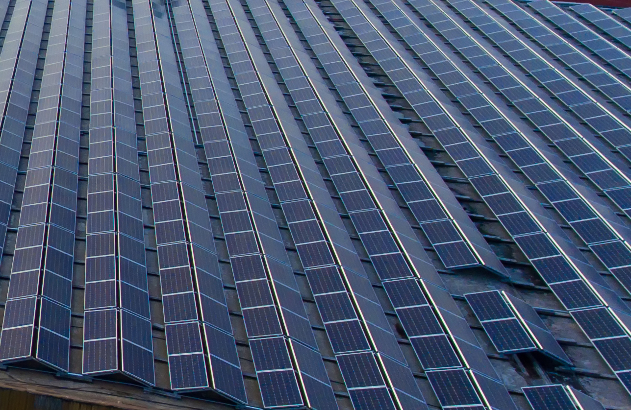 Photovoltaic Cells Covering Roof Industrial Premises Two Workers Standing Solar Panels Village Houses Background